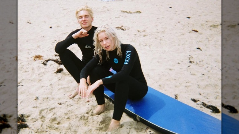 Elle Chapman sits at the beach wearing a wetsuit