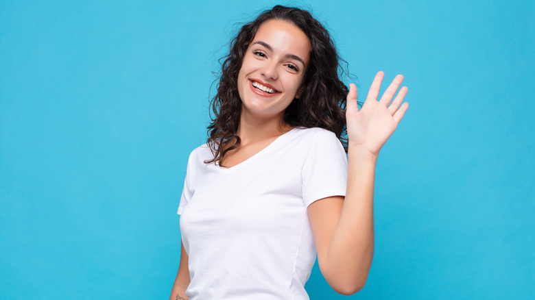 Woman waves goodbye