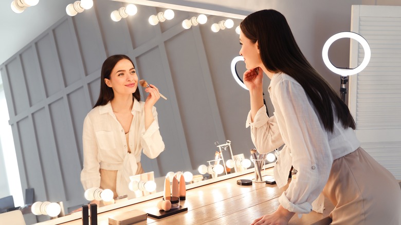 Woman applying makeup 