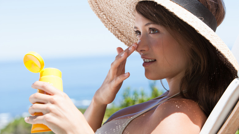 young woman applying retinol sunscreen