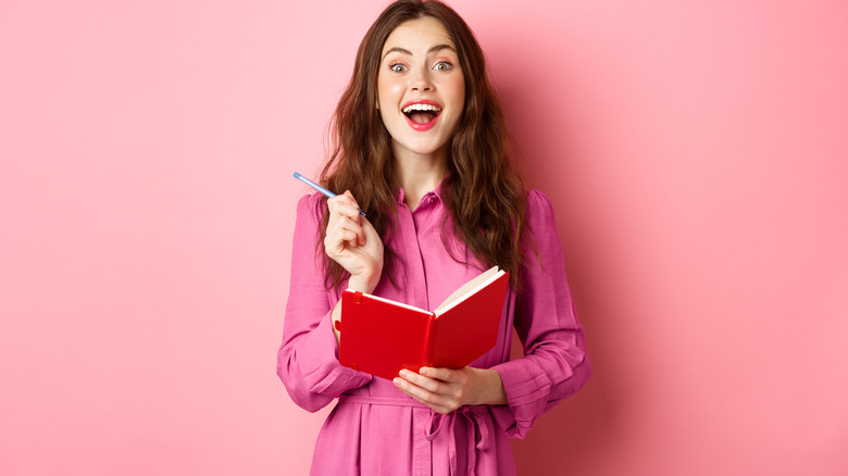 Woman writing in planner