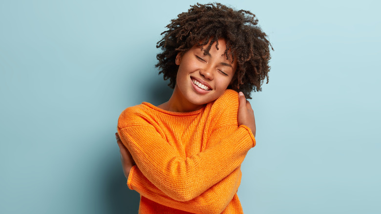 woman hugging herself