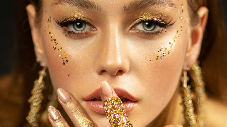 Woman wearing gold makeup