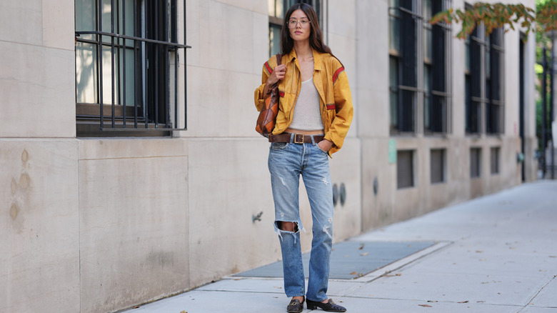 A woman wearing ripped jeans