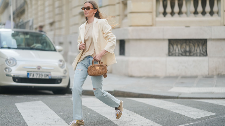 A woman wearing ripped jeans
