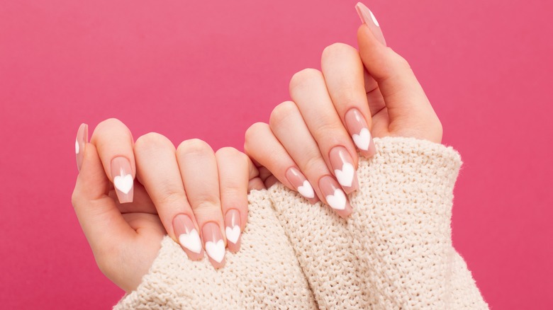Fingernails with heart-shaped polish