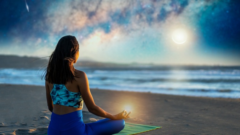 Girl meditating outside under moon