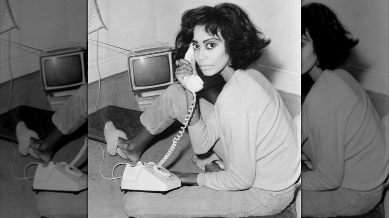 A portrait of Donyale Luna holding a phone in 1966 in black and white