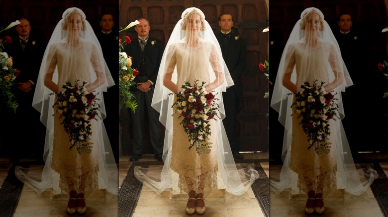 Laura Carmichael pictured as Lady Edith wearing a lace short-sleeved wedding gown