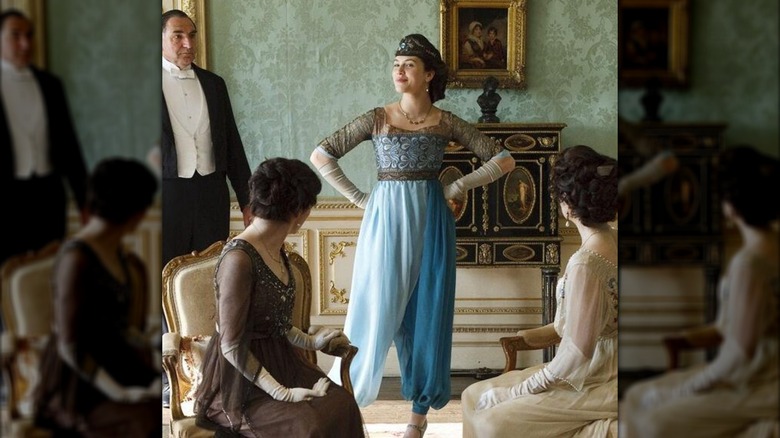 Jessica Brown Findlay as Lady Sybil wearing turquoise harem pants and a brown headband
