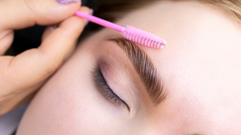 woman getting her eyebrows done