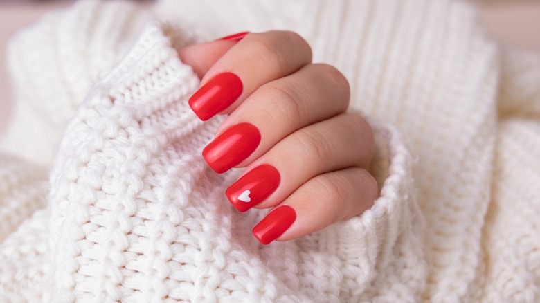 red nails with white heart painted
