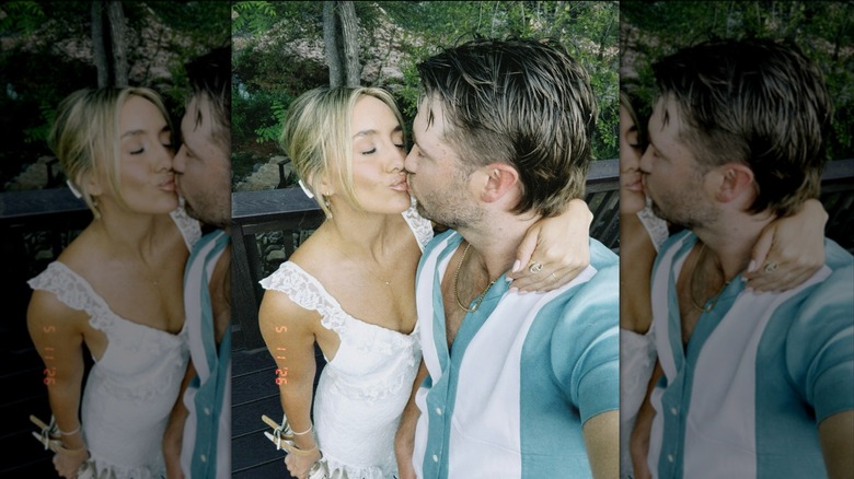 Lainey Wilson kisses husband Duck in her wedding dress