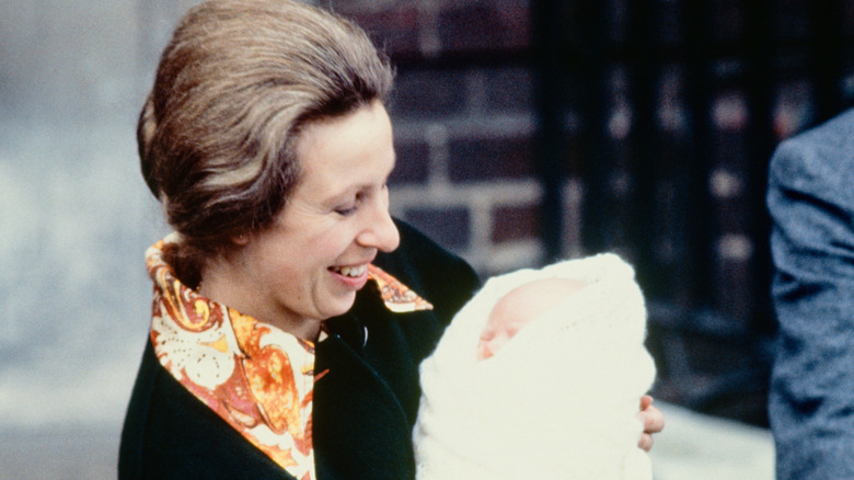 Princess Anne holding baby Zara Phillips in London, England