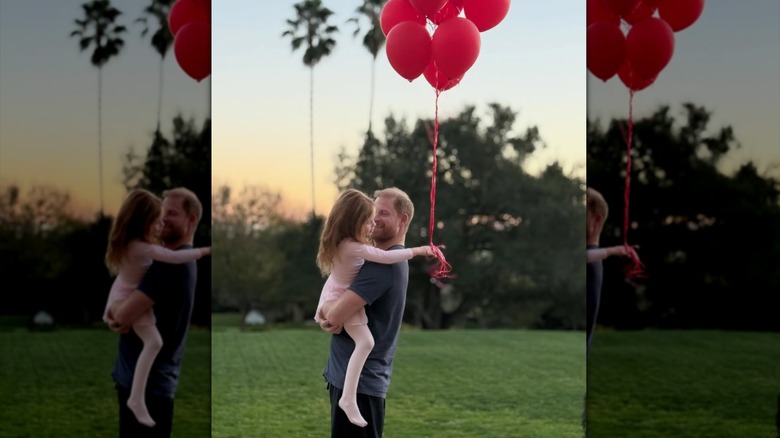Prince Harry holds his daughter Princess Lilibet