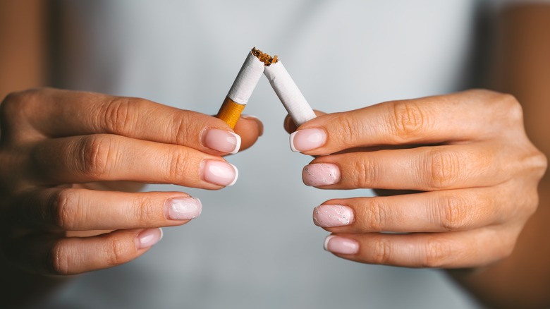 person holding broken cigarette 