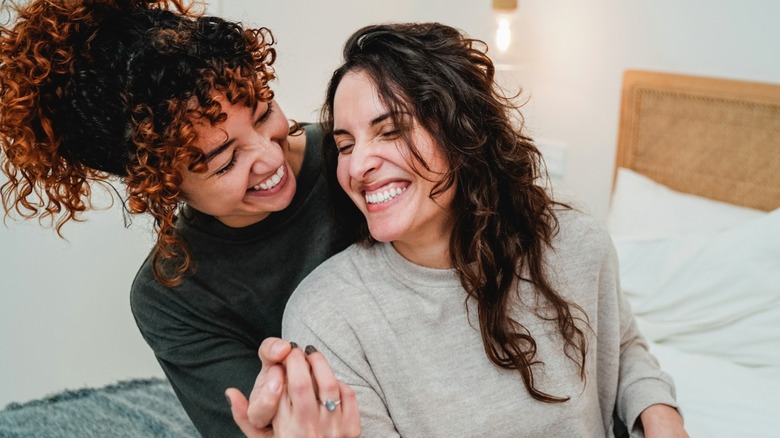 couple laughing on bed