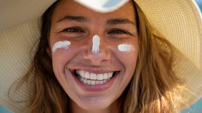 Model wearing sunhat and sunscreen