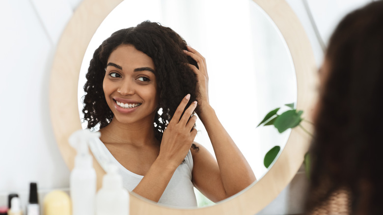 smiling woman touching hair