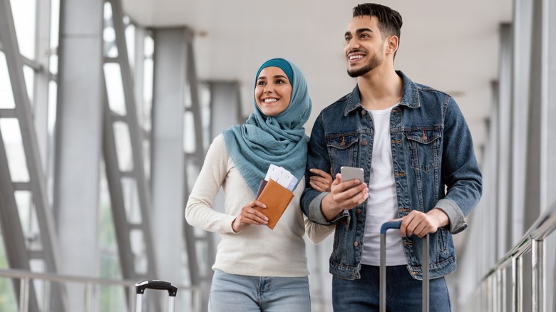 Couple with suitcases and passports