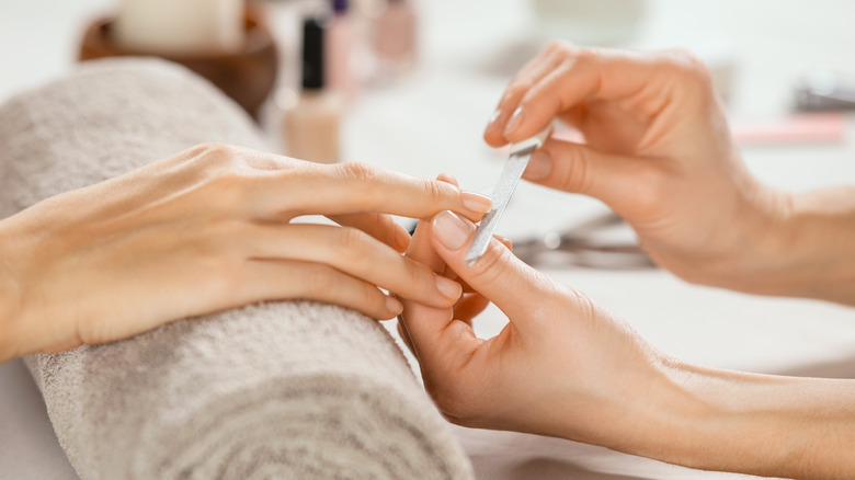 woman having nails filed