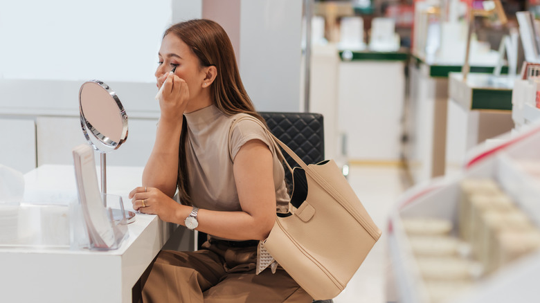 Woman applying eyeliner