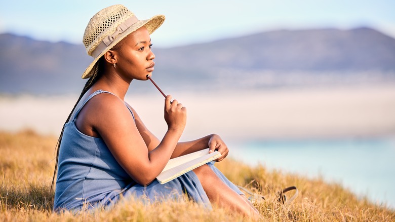 Woman journals outdoors