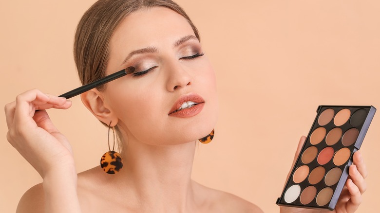 woman applying eyeshadow