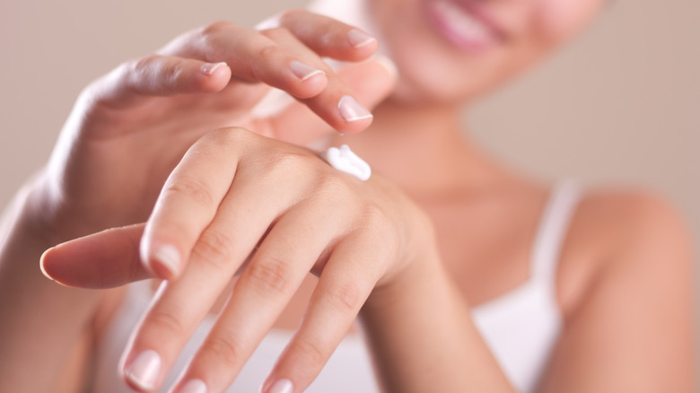 woman applying hand cream