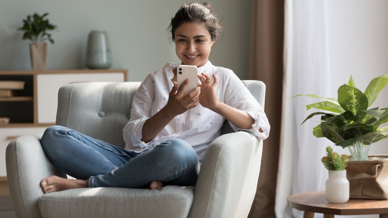 Woman smiles at phone