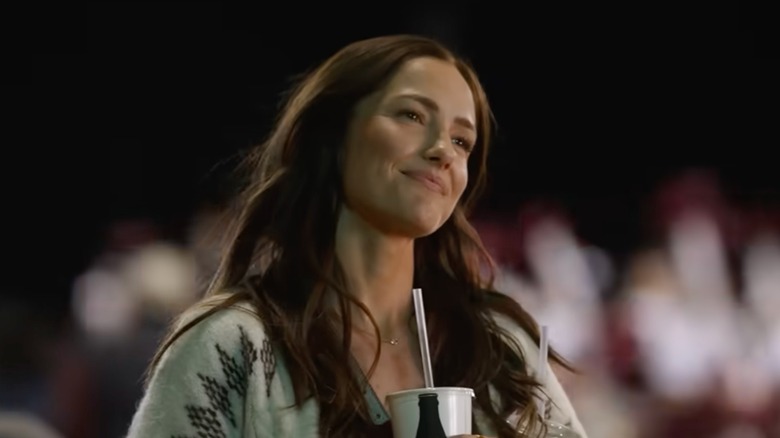 Minka Kelly smiles in front of a blurred background as Quinn O'Grady in Ransom Canyon