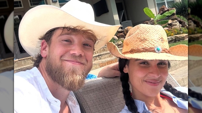 Marianly Tejada and husband Steve Bean pose for a selfie with cowboy hats on