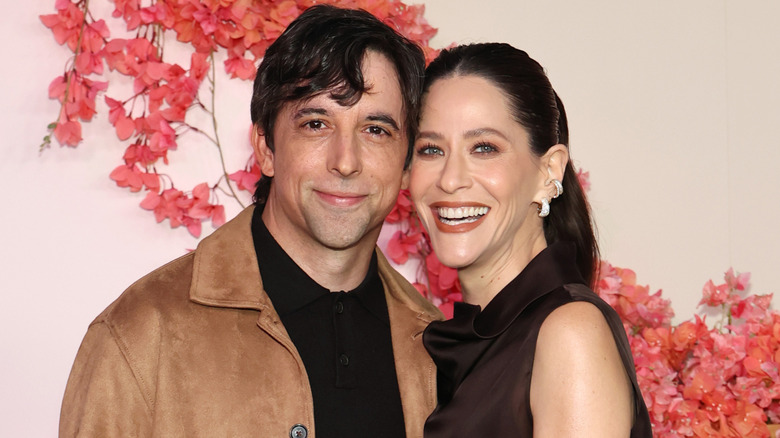 Jackie Tohn and boyfriend Joe Gillette smile as they pose for cameras on the red carpet.