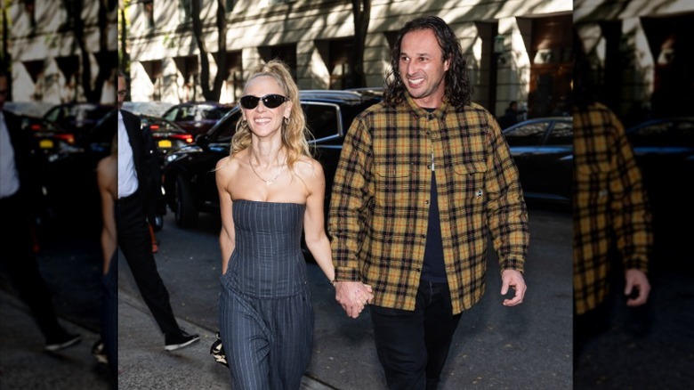 June Temple and Michal Szymanski hold hands as they walk