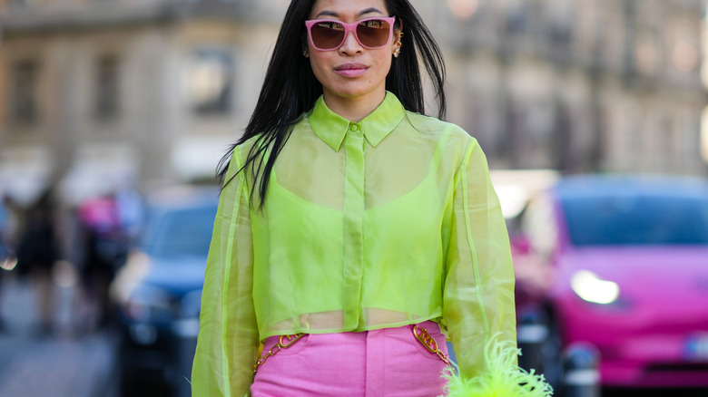 Woman wears sheer neon top