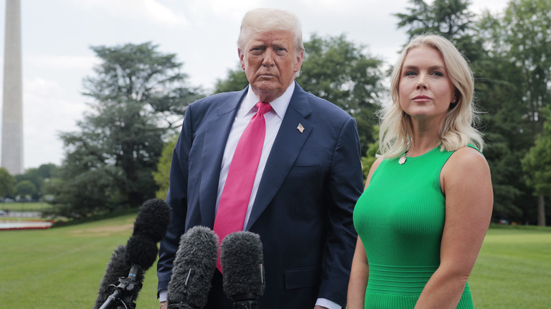 Karoline Leavitt in a green dress beside Donald Trump