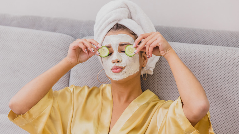 woman wearing clay mask and towel