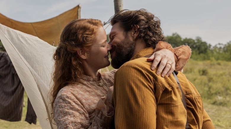 Luke Bracey and Crosby Fitzgerald embracing for a kiss in a screenshot from the Netflix show 'Little House on the Prairie.'