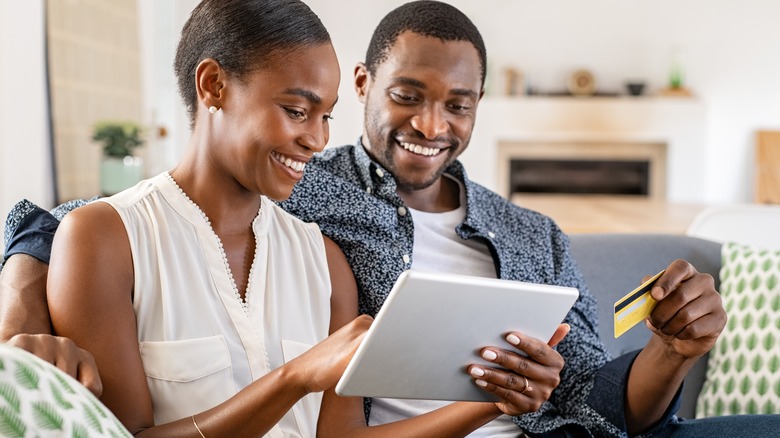 Couple makes a purchase using a tablet