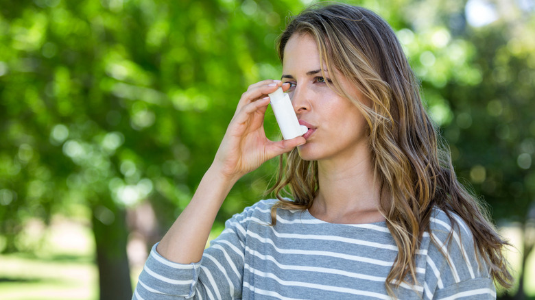 Woman using an inhaler 