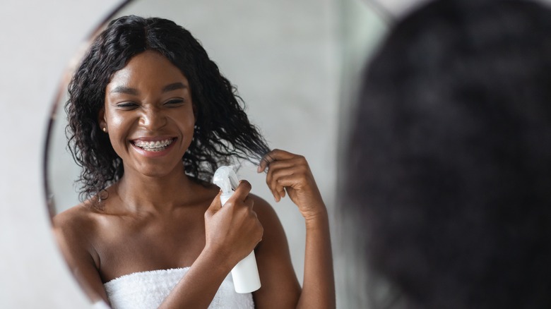 woman styling wavy hair