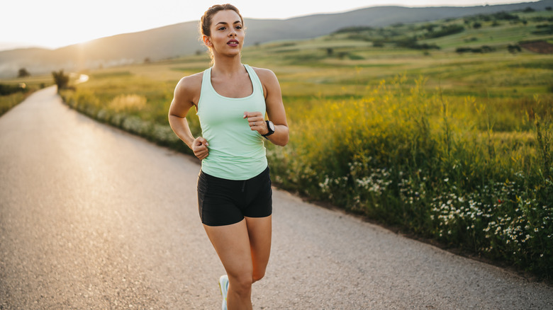 Woman jogging near field