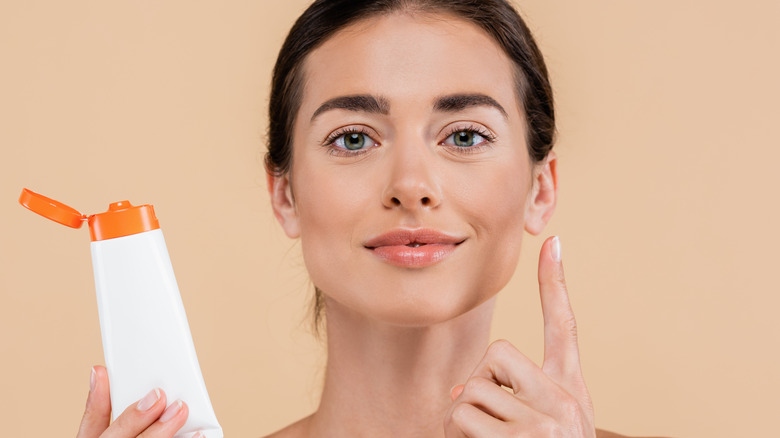 woman applying skincare summer