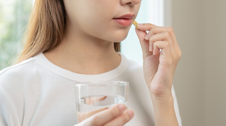 Woman taking a pill