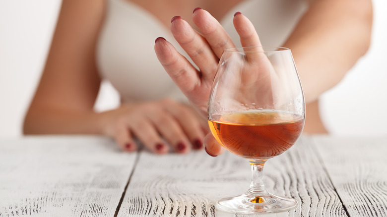 Woman rejecting alcohol with hand