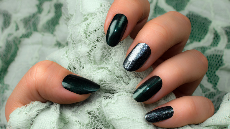 Model showing green manicure