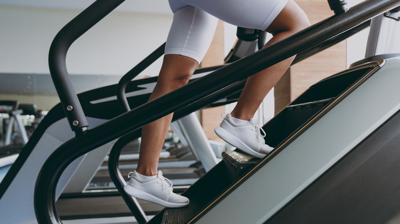 Woman using StairMaster machine