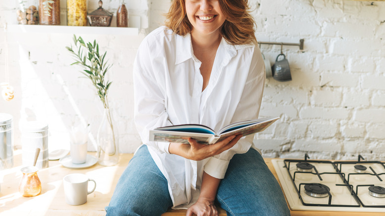 woman sitting on kitchen counter