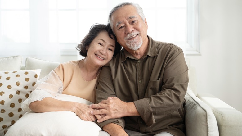 Couple sitting on couch smiling