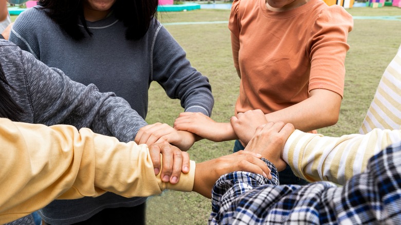 group of people linking arms